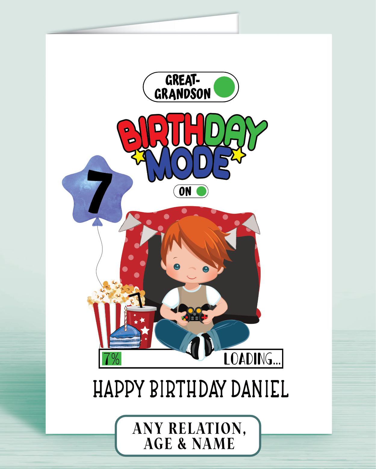 Birthday card with a cartoon boy with Red Hair, popcorn, and video game controller & a blue birthday balloon with age 7 as example.
