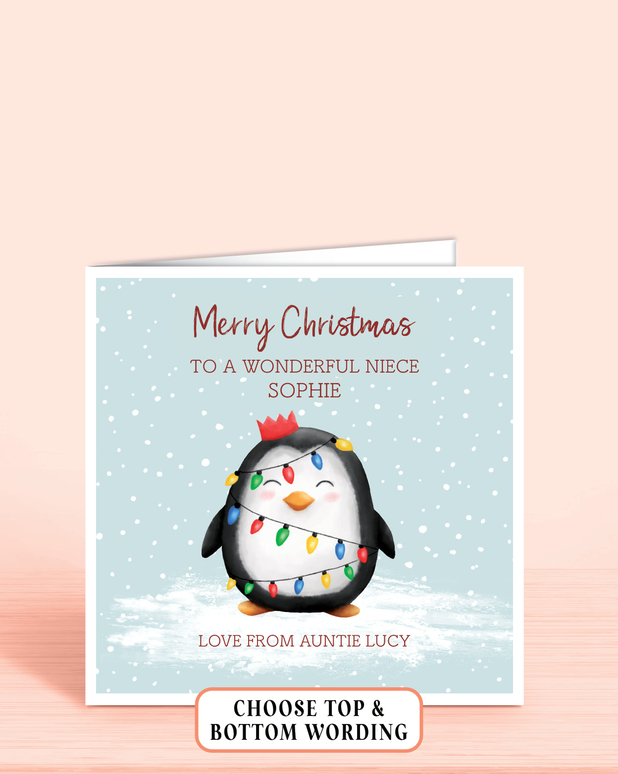 Personalised Christmas card with a cheeky penguin holding christmas lights on a light blue snowy background, 6x6 inches with envelope