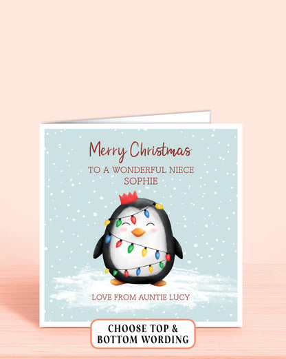 Personalised Christmas card with a cheeky penguin holding christmas lights on a light blue snowy background, 6x6 inches with envelope