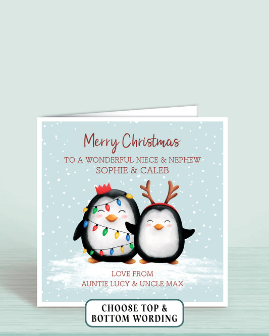 Personalised Christmas card with two cheeky penguins holding christmas lights on a light blue snowy background, 6x6 inches with envelope