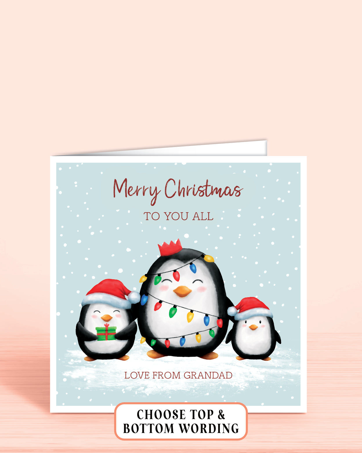 Personalised Christmas card with three cheeky penguins holding christmas lights on a light blue snowy background, 6x6 inches with envelope