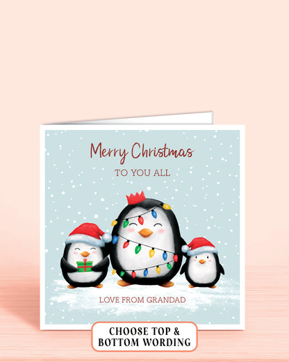 Personalised Christmas card with three cheeky penguins holding christmas lights on a light blue snowy background, 6x6 inches with envelope