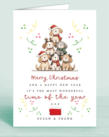 A Dog Lovers christmas card with a stack of christmas tree shaped Puppies and text underneath that reads: Merry Christmas and a happy new year it's the most wonderful time of the year xxx - Name(s) are optional.
