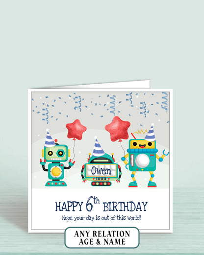 Birthday card with robots holding balloons and text on a light grey background. Reads: Happy 6th Birthday Hope your day is out of this world, add childs name if required | Oliver Rose Designs