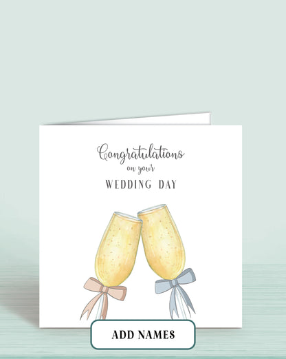 Wedding Day Card with Printed Champagne Glasses with Pink & Blue Bow. Words Read: Congratulations on your Wedding Day.